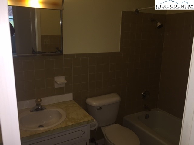 465 Highland Avenue Boone, NC 28607 - Photo 8 of 10 a bathroom with a toilet a sink and mirror