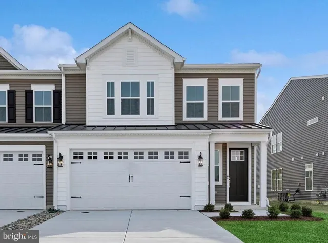 a front view of a building with a yard