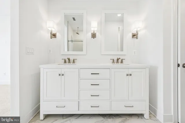 a bathroom with a sink vanity and mirror