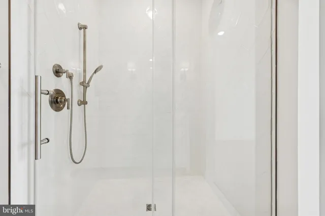 a bathroom with a glass shower door