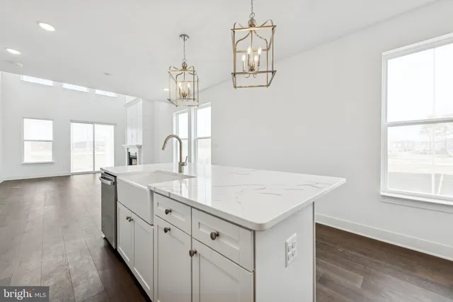 a view of a kitchen sink and chandelier
