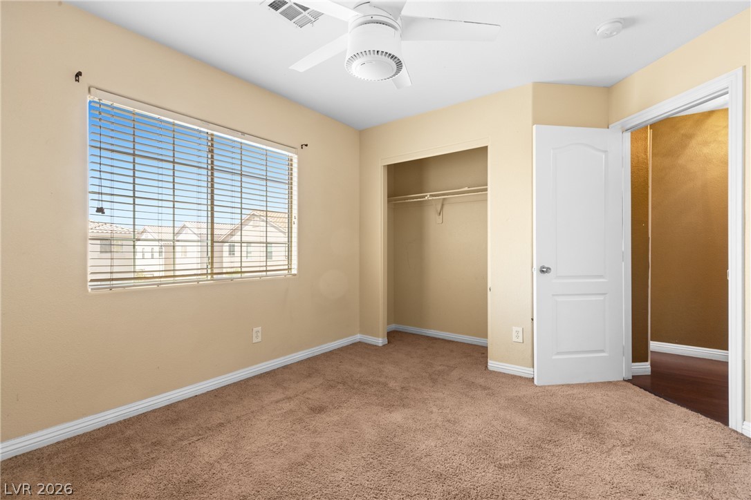 8934 Deep Ridge Court Las Vegas, NV 89178 - Photo 16 of 47 Comfortable bedroom with neutral tones and a broad window providing natural light, ideal for peaceful slumber.