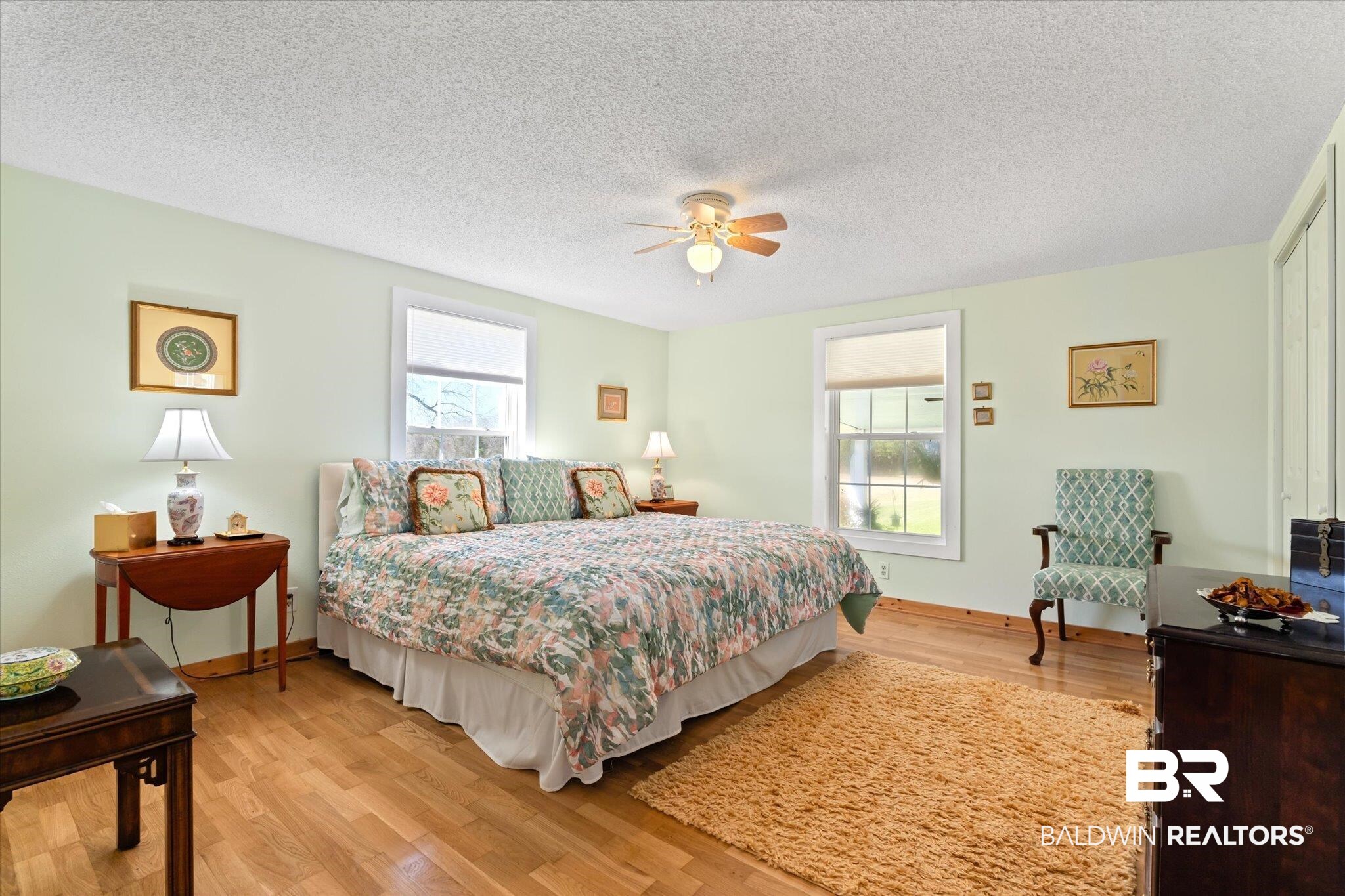 14280 Cat Deakle Road Grand Bay, AL 36541 - Photo 20 of 51 Bedroom with baseboards, ceiling fan, light wood-style flooring, and a textured ceiling