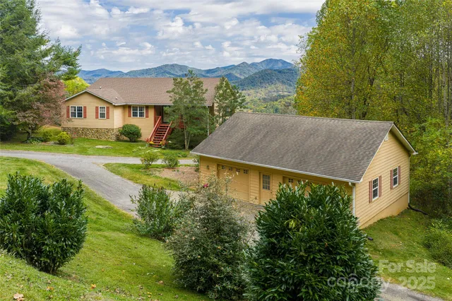 a aerial view of a house next to a yard