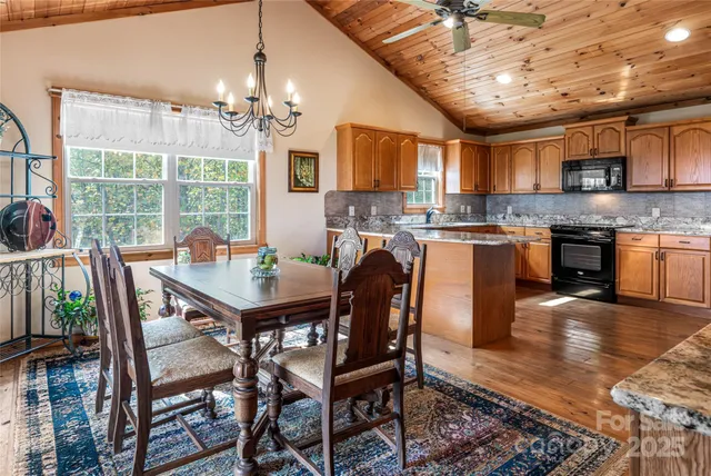 a view of a dining room with furniture a chandelier and wooden floor