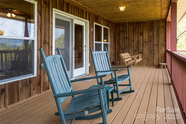 a view of balcony with wooden floor and outdoor seating