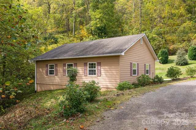 a front view of house with yard and trees