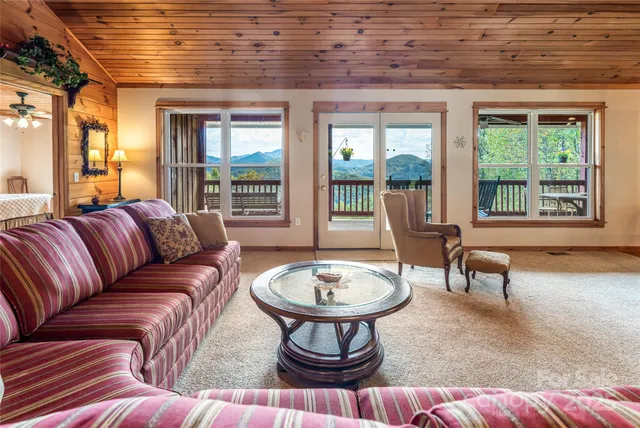 a living room with furniture a window and a chandelier