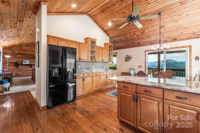 a kitchen with stainless steel appliances wooden floors and wooden cabinets
