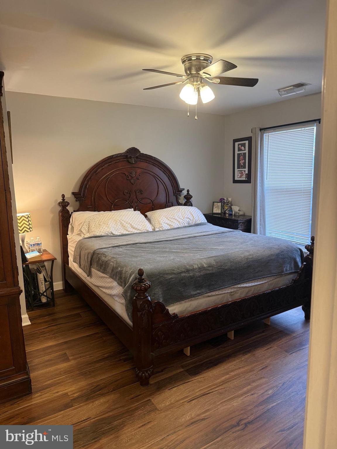 8575 Cold Harbor Loop Manassas, VA 20111 - Photo 11 of 17 a bedroom with a bed lamp and wooden floor