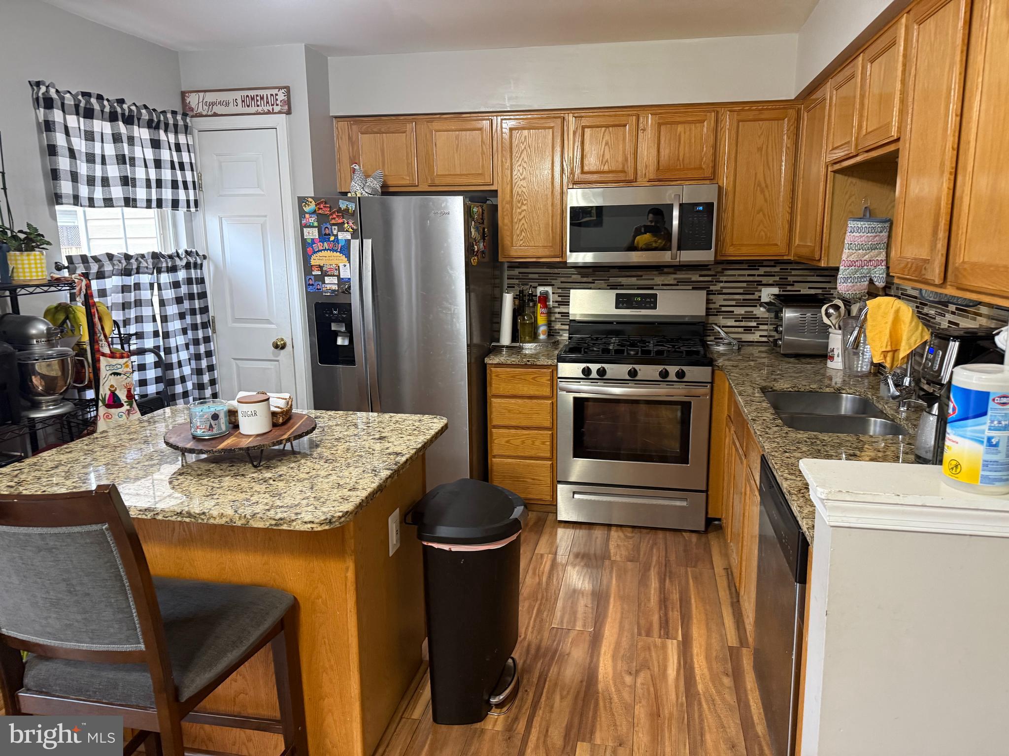 8575 Cold Harbor Loop Manassas, VA 20111 - Photo 6 of 17 a kitchen with stainless steel appliances granite countertop a stove refrigerator and a microwave