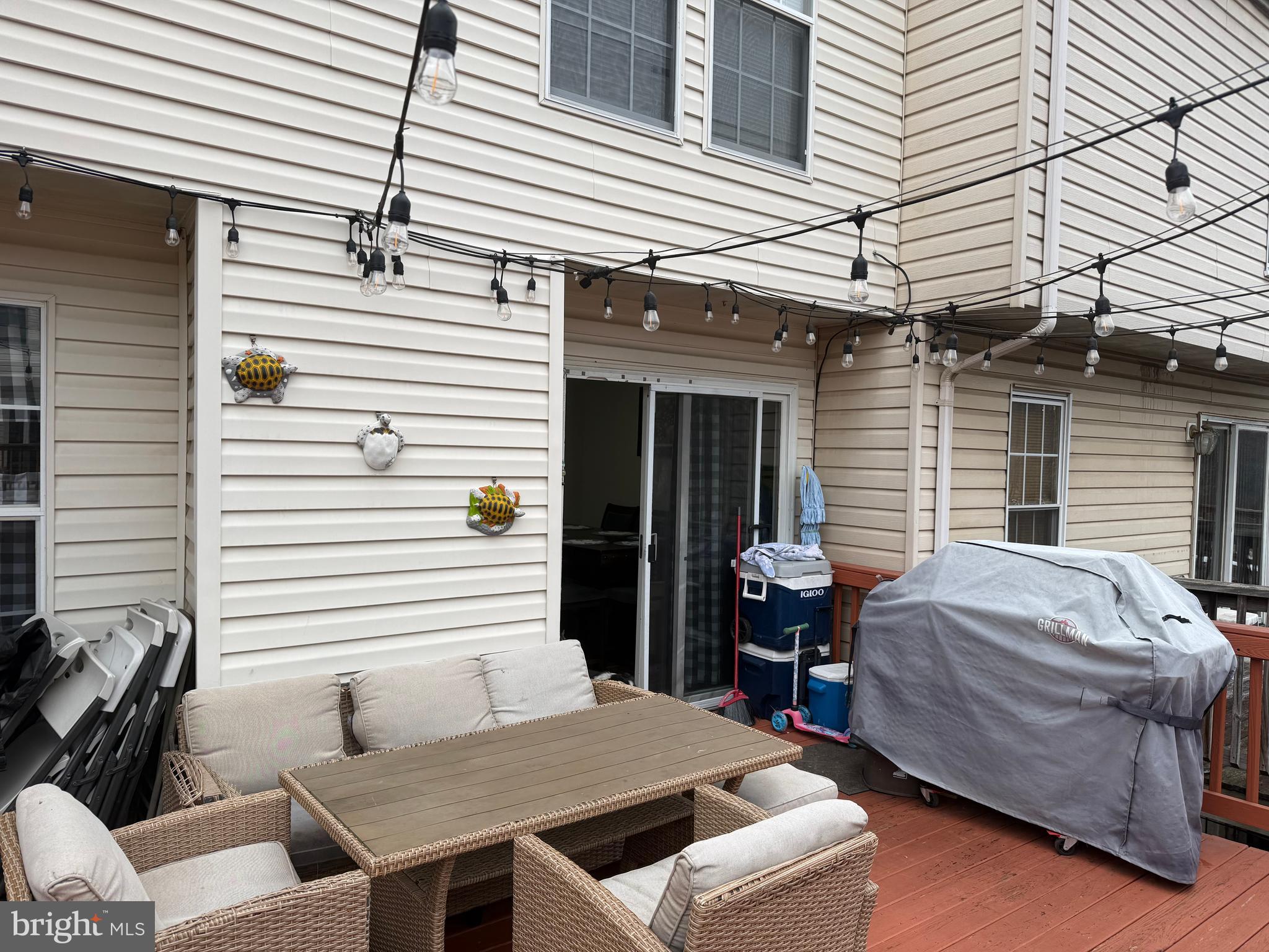 8575 Cold Harbor Loop Manassas, VA 20111 - Photo 9 of 17 a view of a patio that has a table and chairs with wooden floor