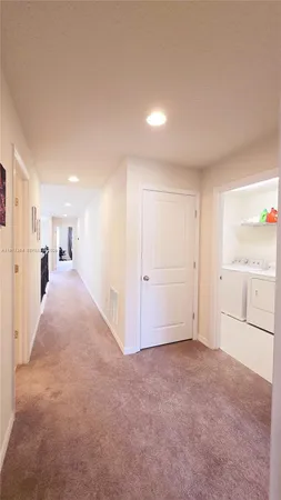 a view of a big room with closet and windows