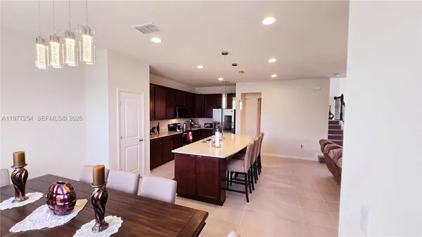 a large kitchen with a table and chairs