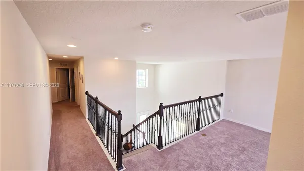 a view of a hallway with staircase