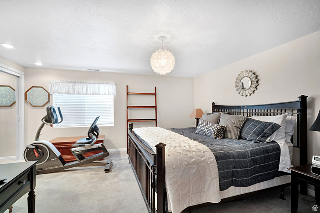 2139 Village Point Way Sandy, UT 84093 - Photo 25 of 35 Large bedroom in basement with mirrored, oversized closet (this is a king sized bed in the photo - this is a nice sized room).