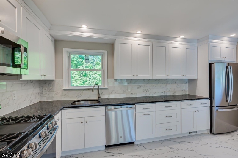 15 Woodmere Street Raritan, NJ 08869 - Photo 8 of 16 a kitchen with white cabinets sink and stainless steel appliances