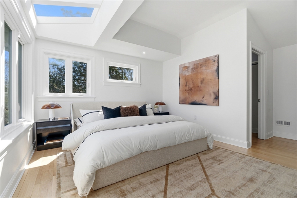 171 Shaw Road Brookline, MA 02467 - Photo 30 of 42 a bedroom with a bed and a couch