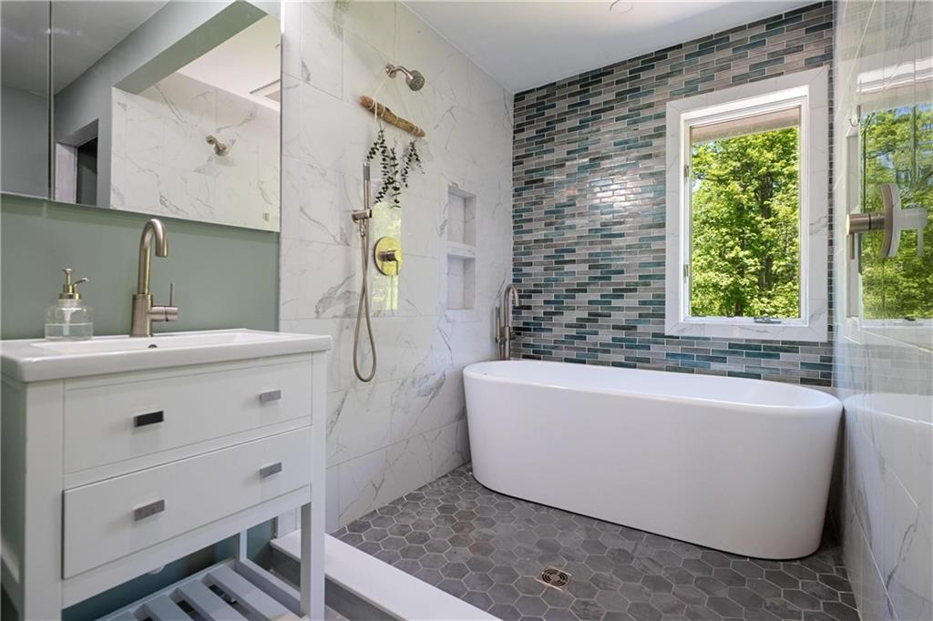 150 Dodds Road Butler, PA 16002 - Photo 31 of 37 a bathroom with a bathtub a sink and a shower
