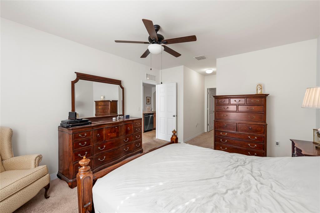 8921 Excelsior Loop Venice, FL 34293 - Photo 11 of 26 a bedroom with a bed and a dresser