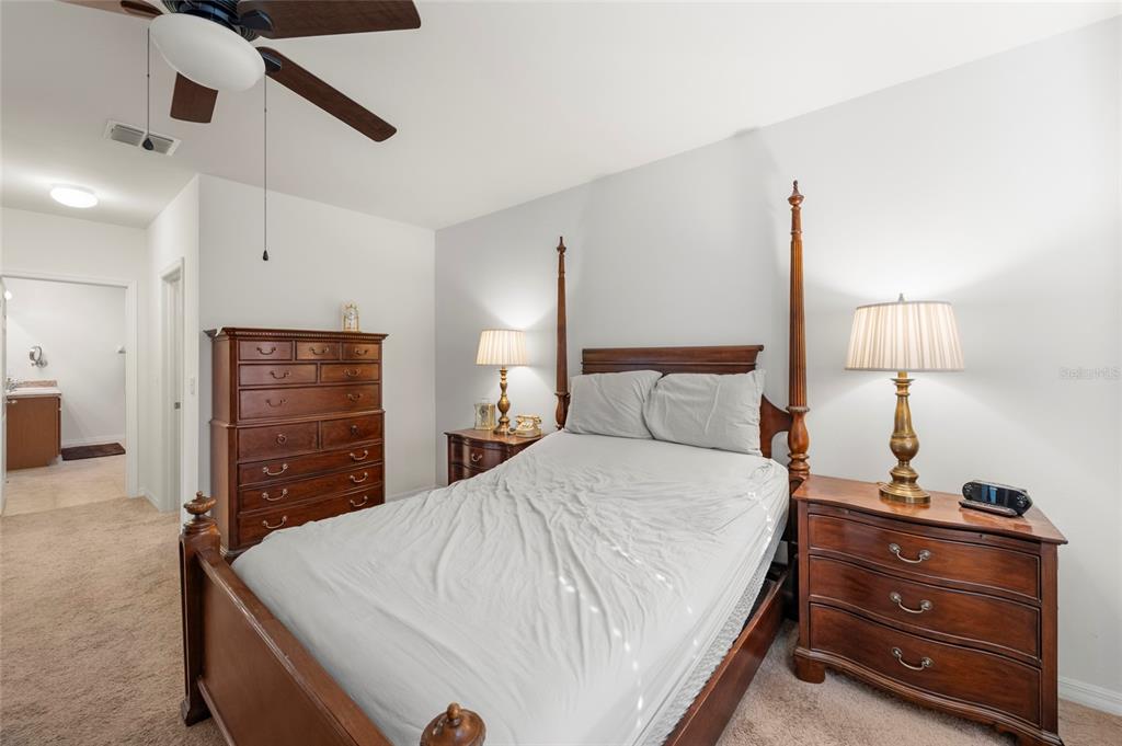 8921 Excelsior Loop Venice, FL 34293 - Photo 12 of 26 a bed room with a bed and a dresser