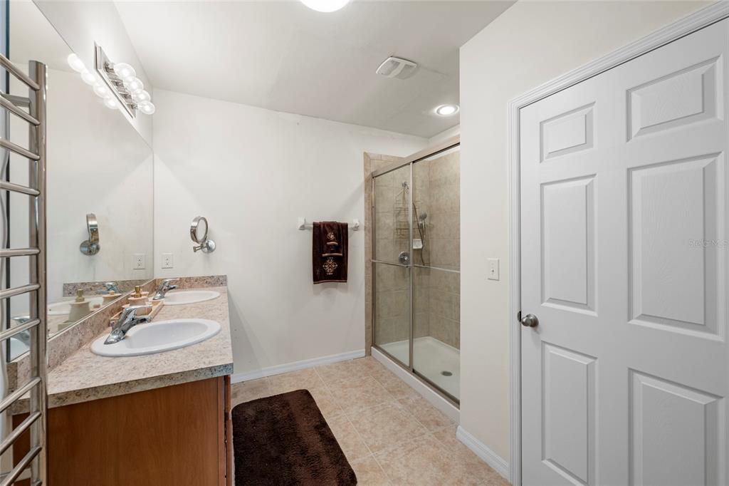 8921 Excelsior Loop Venice, FL 34293 - Photo 13 of 26 a bathroom with a sink double vanity and shower