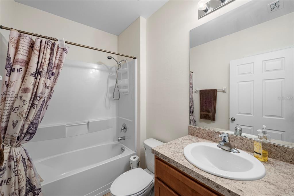 8921 Excelsior Loop Venice, FL 34293 - Photo 16 of 26 a bathroom with a granite countertop sink toilet and shower