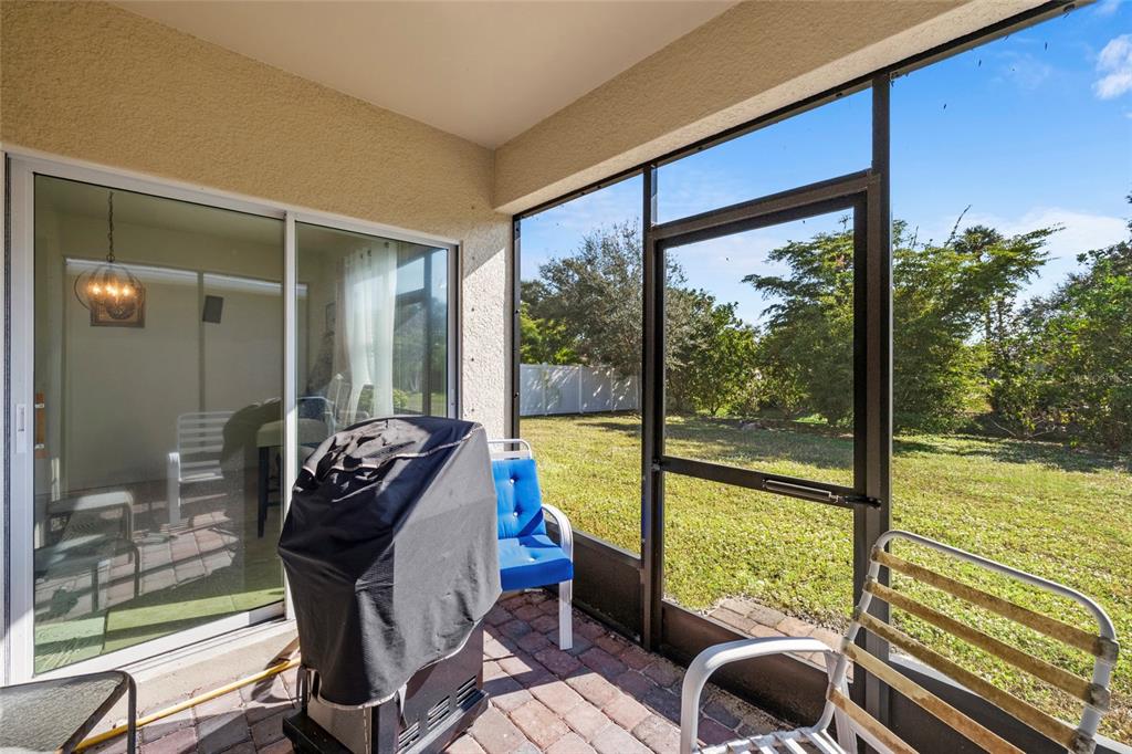 8921 Excelsior Loop Venice, FL 34293 - Photo 21 of 26 a living room with furniture and floor to ceiling windows