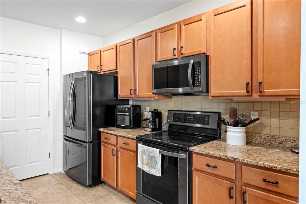 8921 Excelsior Loop Venice, FL 34293 - Photo 5 of 26 a kitchen with stainless steel appliances granite countertop a refrigerator stove a sink and dishwasher