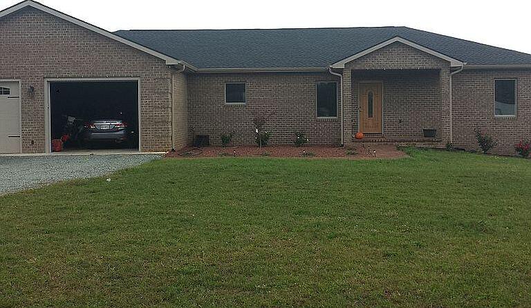 446 Jamestown Road Rocky Mount, VA 24151 - Photo 1 of 1 a backyard of a house with table and chairs