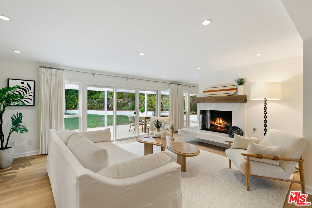 30751 La Brisa Drive Malibu, CA 90265 - Photo 1 of 1 a living room with furniture and a fireplace