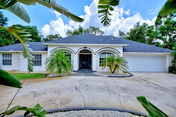 a view of front of house with potted plants
