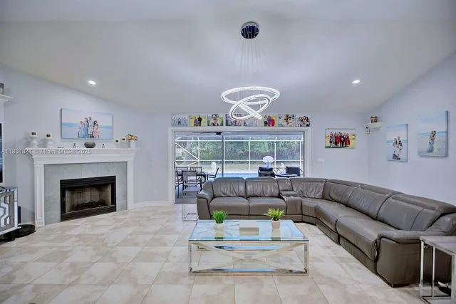 a living room with furniture a fireplace and a ceiling fan