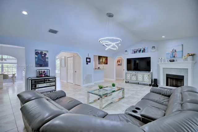 a living room with furniture a flat screen tv and a fireplace