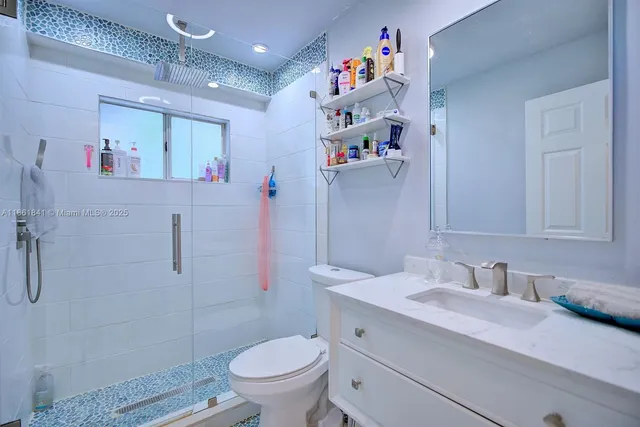 a bedroom with a bed and a tv on the dresser