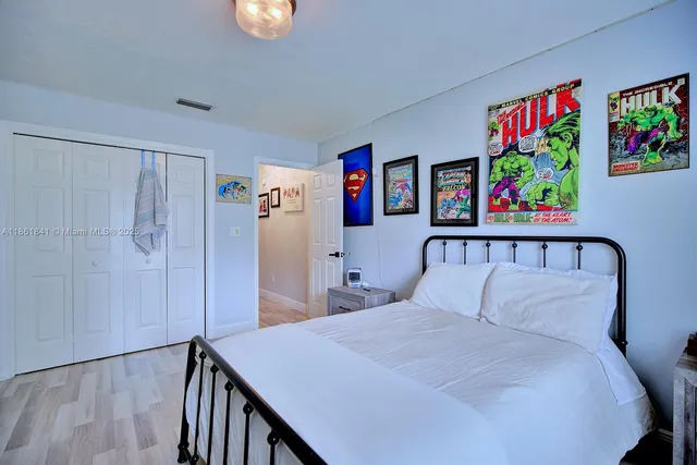 a bed room with a bed window and a chair