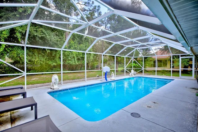 a view of a backyard with swimming pool