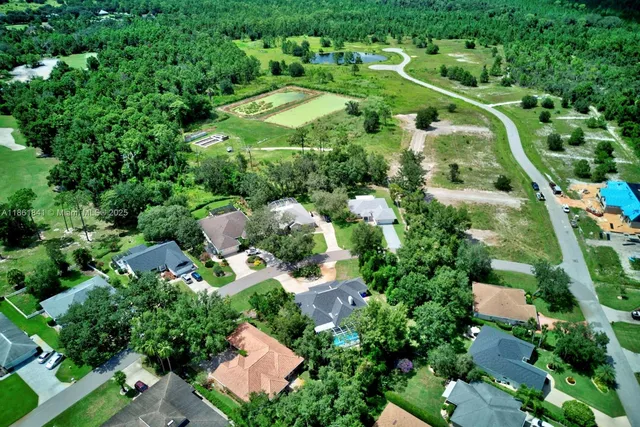 an aerial view of a house with a yard