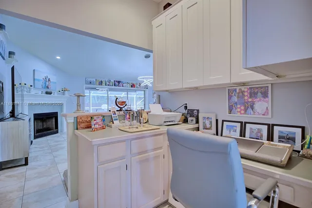 a living room with furniture a fireplace and a kitchen view