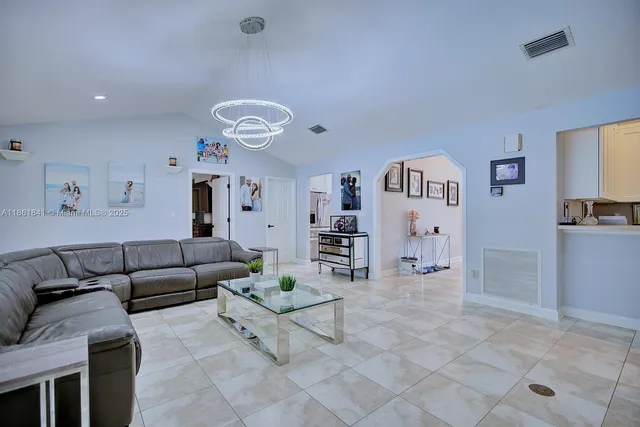 a living room with furniture and painting on the wall