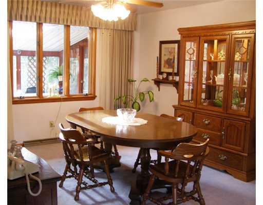 Dining Room. The dining area is an Ell off the living room. The picture window offers a view of the screened patio, easily access thru the walk out off to the left.