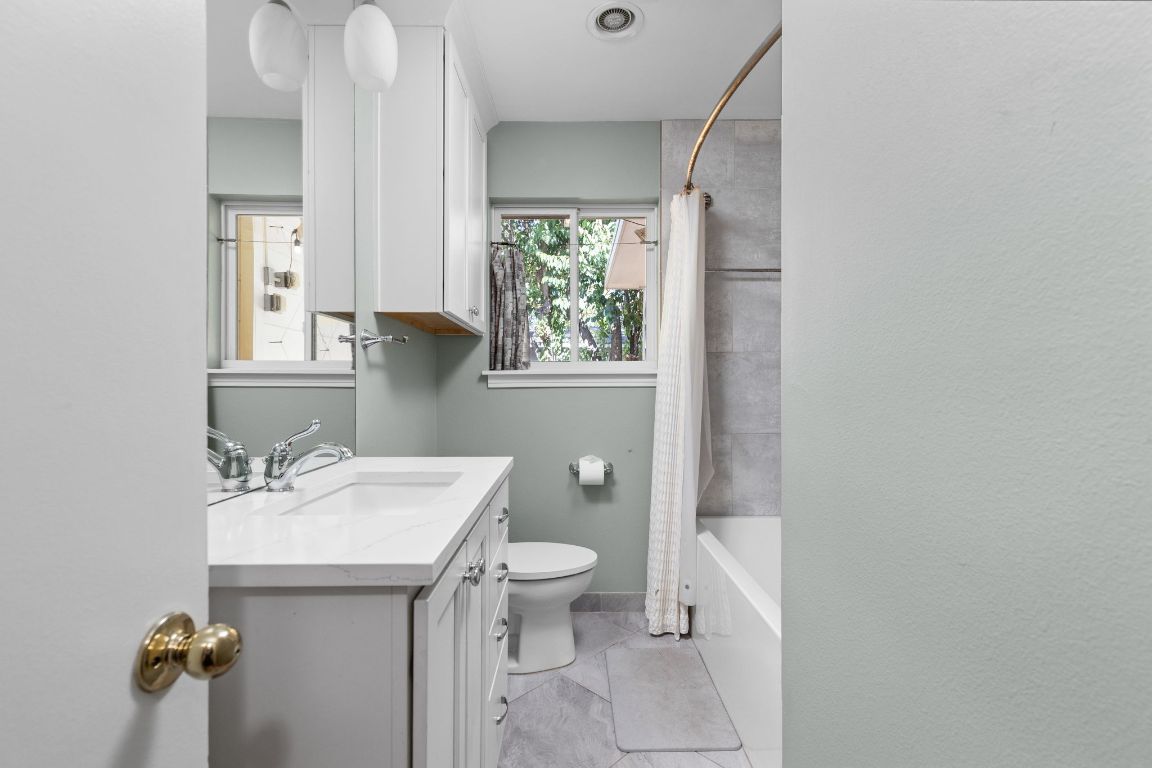 1105 Alegria Road Austin, TX 78757 - Photo 12 of 30 a bathroom with a sink toilet and mirror