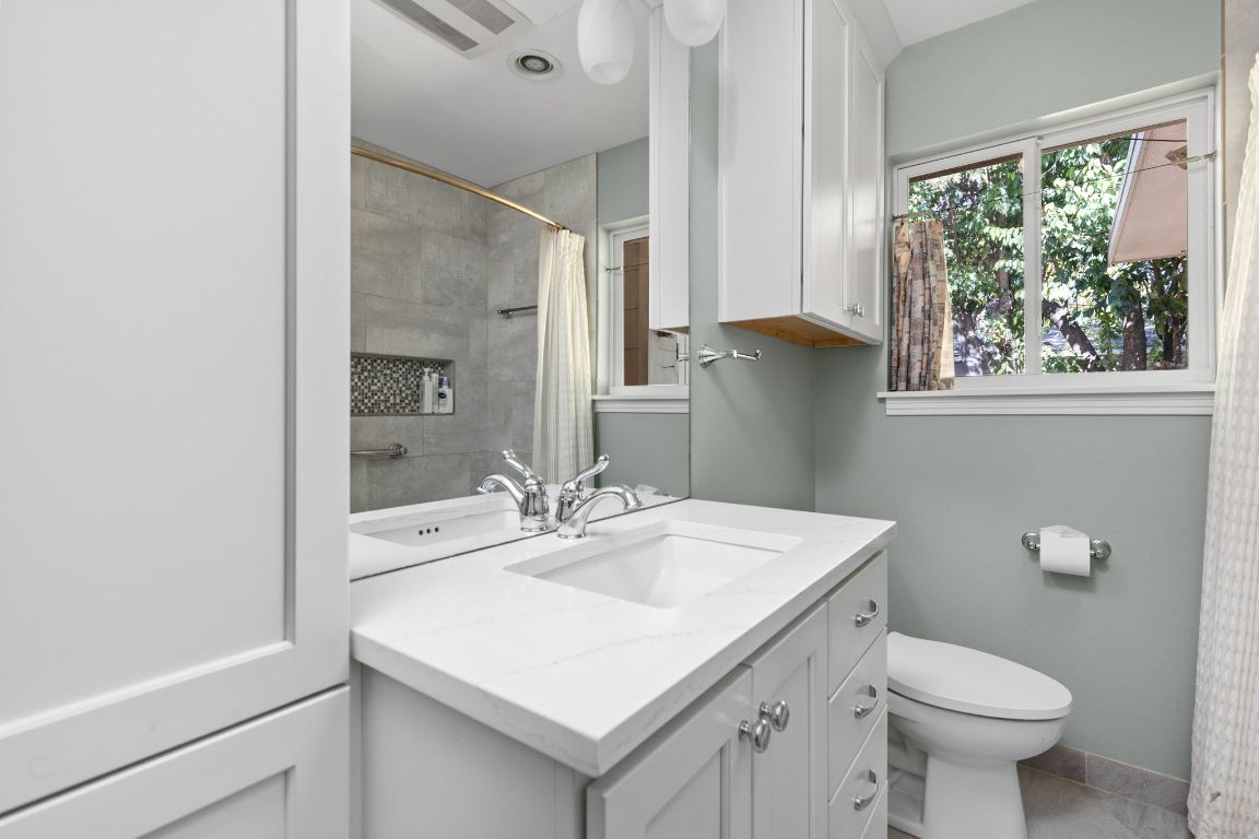 1105 Alegria Road Austin, TX 78757 - Photo 13 of 30 a bathroom with a sink toilet and a mirror