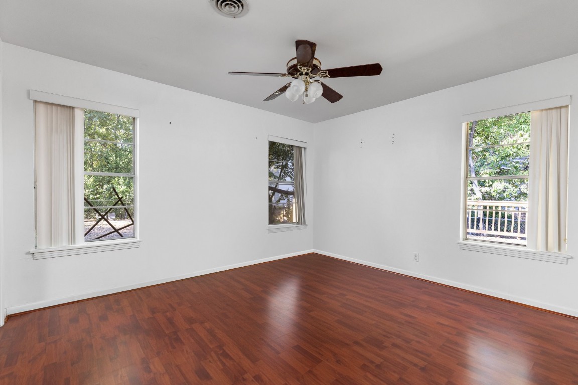 1105 Alegria Road Austin, TX 78757 - Photo 21 of 30 a view of an empty room with wooden floor and a window