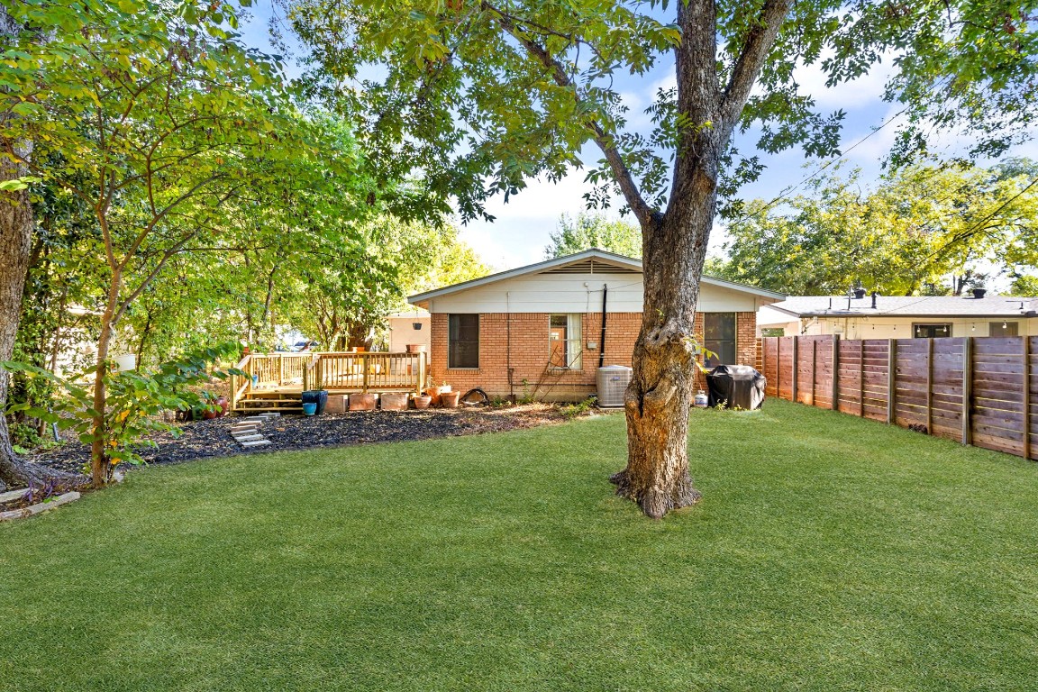 1105 Alegria Road Austin, TX 78757 - Photo 29 of 30 a front view of a house with garden and trees