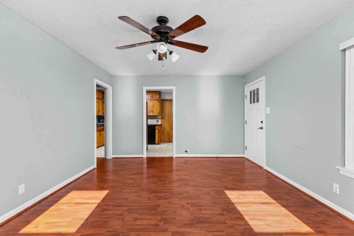 1105 Alegria Road Austin, TX 78757 - Photo 5 of 30 wooden floor in an empty room with a window