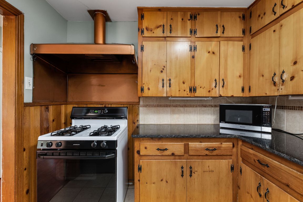 1105 Alegria Road Austin, TX 78757 - Photo 8 of 30 a kitchen with a stove and a cabinet