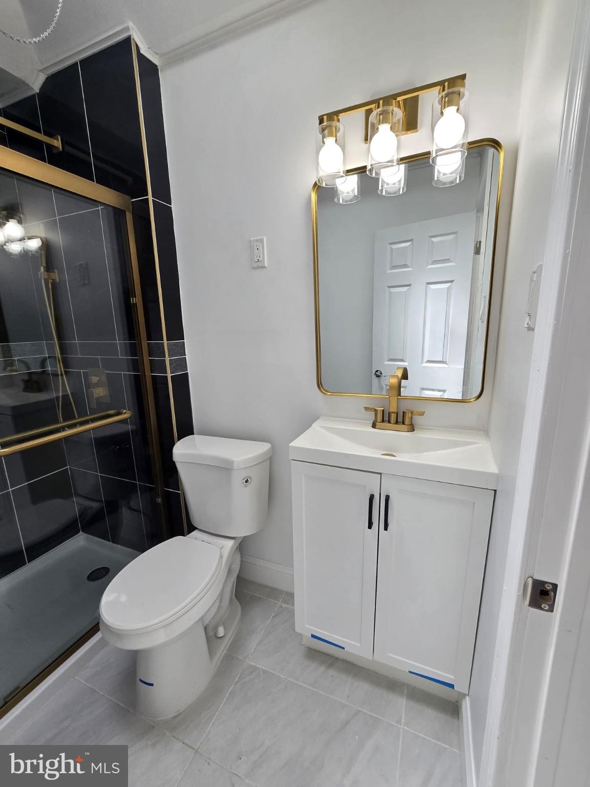 6824 Rodney Street Philadelphia, PA 19138 - Photo 17 of 28 a bathroom with a toilet a sink and a mirror