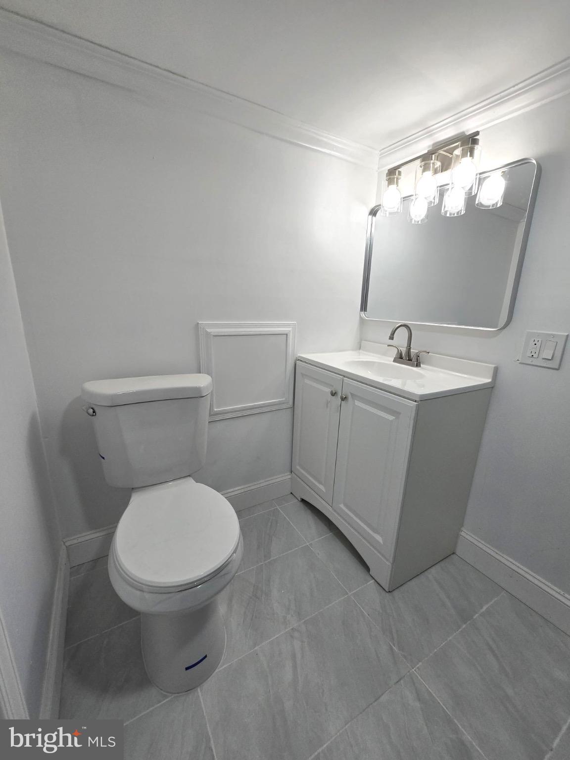 6824 Rodney Street Philadelphia, PA 19138 - Photo 28 of 28 a bathroom with a toilet sink and mirror