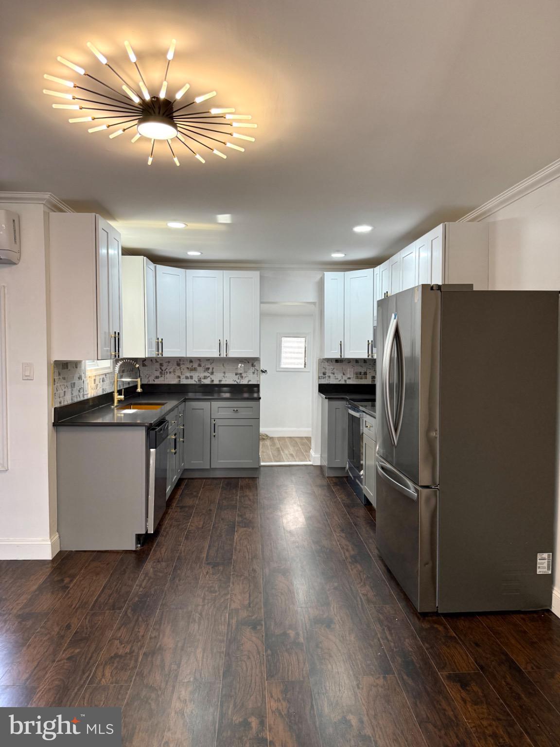 6824 Rodney Street Philadelphia, PA 19138 - Photo 4 of 28 a kitchen with stainless steel appliances kitchen island granite countertop a refrigerator a sink dishwasher a stove and a refrigerator